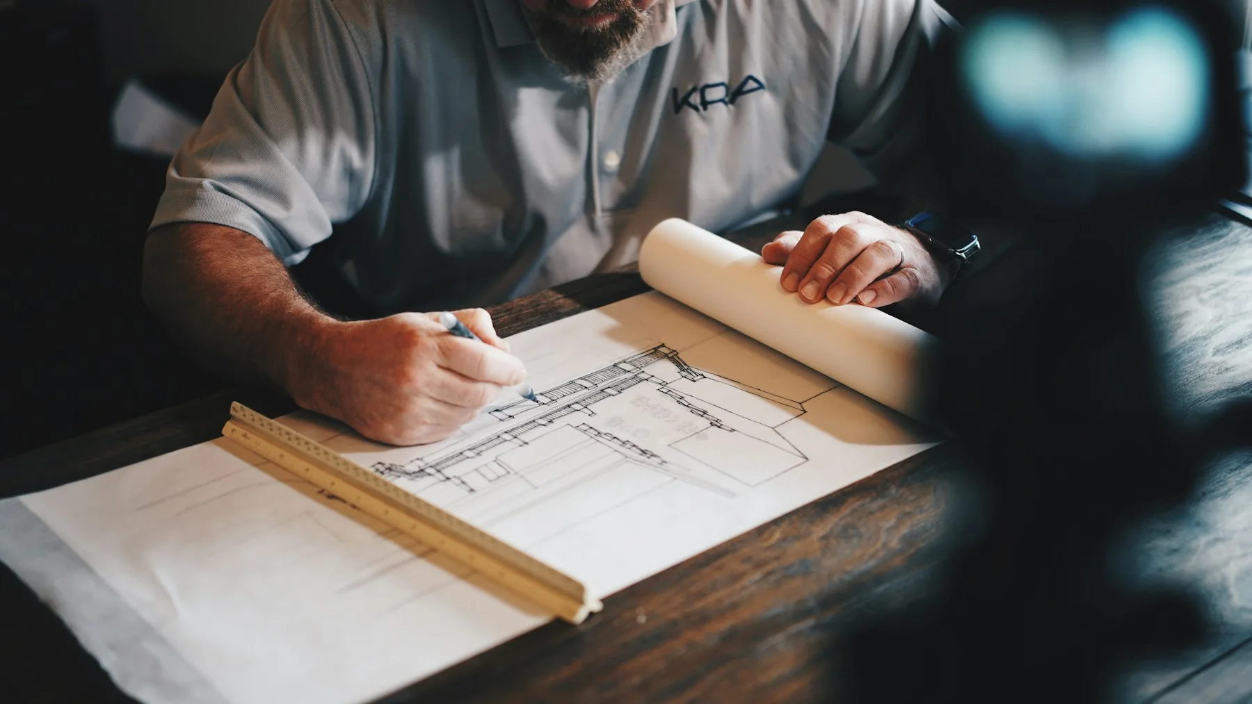 Architectural plans being developed at a drafting table